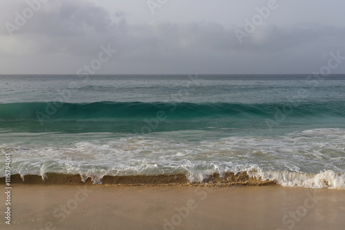 Beautiful turquoise waves of Atlantic Ocean on grey gloomy day in Cabo Verde.