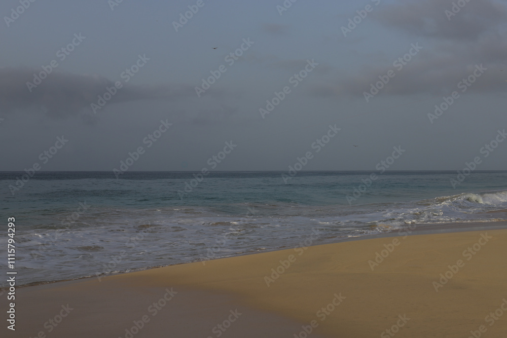 Beautiful turquoise waves of Atlantic Ocean on grey gloomy day in Cabo Verde. Beautiful turquoise waves of Atlantic Ocean on grey gloomy day in Cabo Verde.