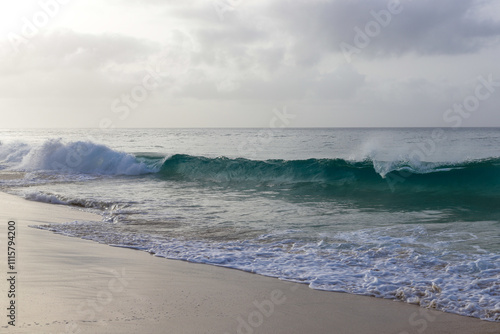 Beautiful turquoise waves of Atlantic Ocean on grey gloomy day in Cabo Verde.