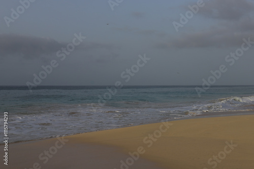 Beautiful turquoise waves of Atlantic Ocean on grey gloomy day in Cabo Verde.