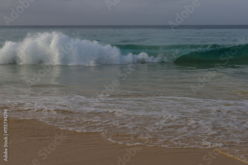 Beautiful turquoise waves of Atlantic Ocean on grey gloomy day in Cabo Verde.