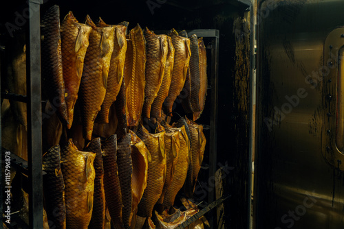 Carp carcasses in a smokehouse at a production facility photo