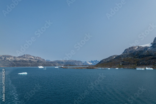 Prins Christian Sund Greenland mountain fjord with floating ice and shore iceberg on a summer day