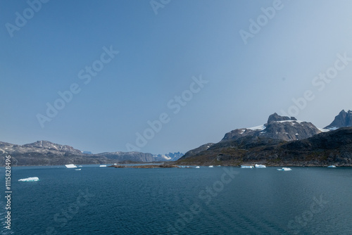 Prins Christian Sund Greenland mountain fjord with floating ice and shore iceberg on a summer day