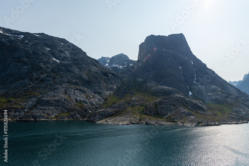 Prins Christian Sund Greenland mountain fjord with floating ice and shore iceberg on a summer day