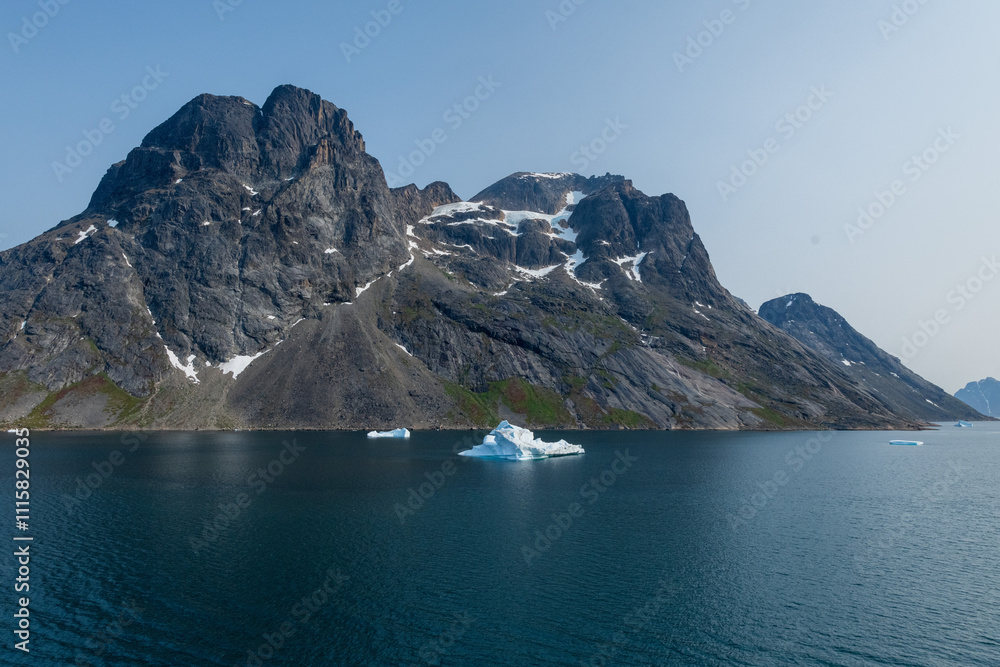 Obraz premium Prins Christian Sund Greenland mountain fjord with floating ice and shore iceberg on a summer day