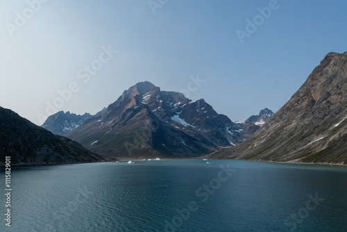 Prins Christian Sund Greenland mountain fjord with floating ice and shore iceberg on a summer day photo