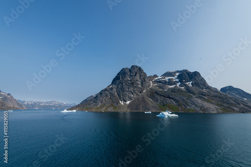 Prins Christian Sund Greenland mountain fjord with floating ice and shore iceberg on a summer day