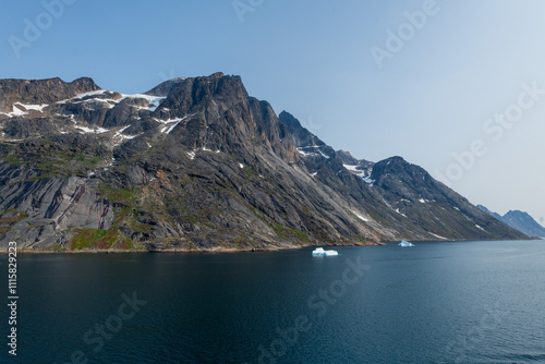 Prins Christian Sund Greenland mountain fjord with floating ice and shore iceberg on a summer day photo