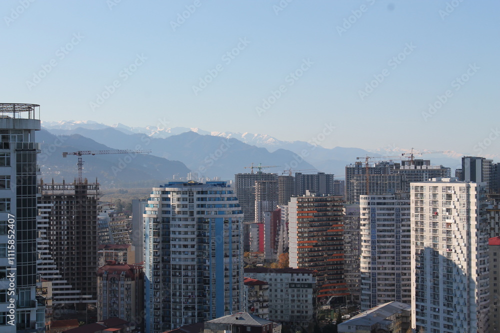 Fototapeta premium Multi-level chaotic development in Batumi, Georgia, on a sunny day. The variety of architectural styles and high-rise buildings forms a unique urban landscape 