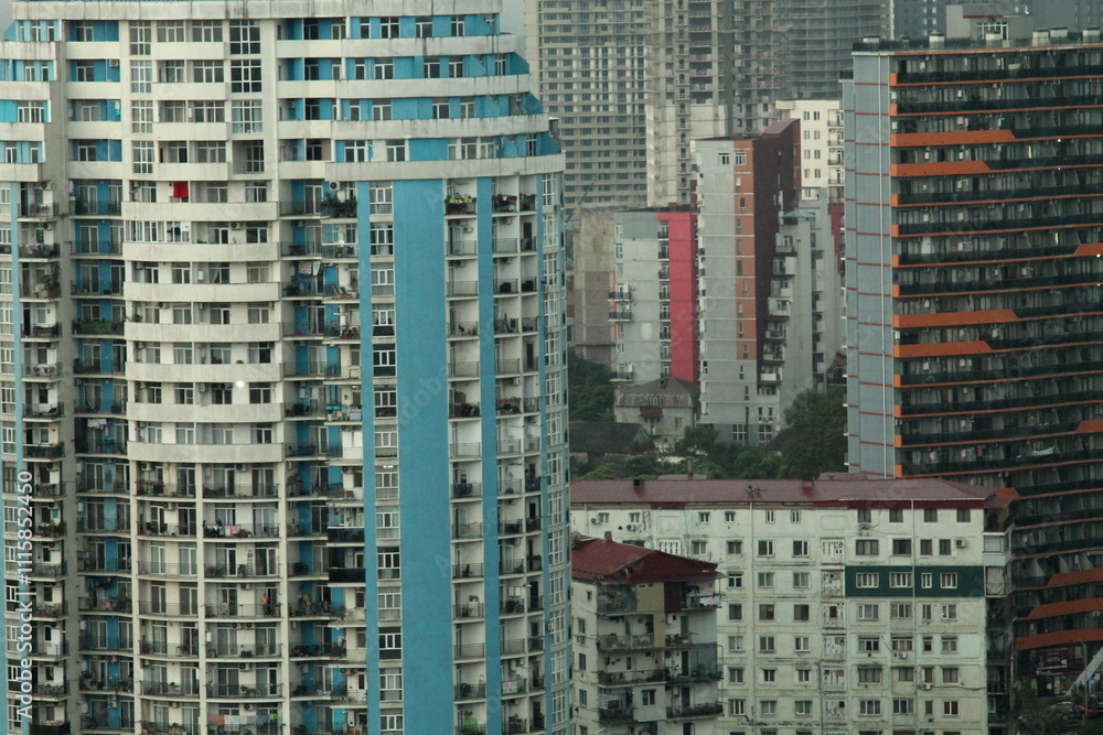 Obraz premium Multi-level chaotic development in Batumi, Georgia, rainy day. The variety of architectural styles and high-rise buildings form a unique urban landscape.