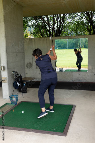 Golfer Practice in Driving Range and a Golf Bag with Golf Clubs and Mirror Image in Switzerland.