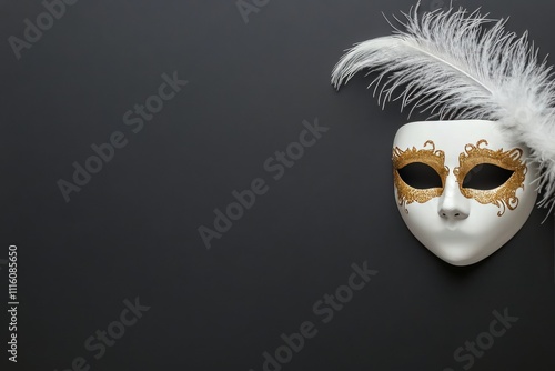 Elegant white mask with gold accents and feathers displayed against a dark ba...
