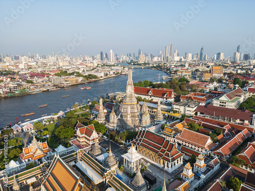 Aerial view buddha Temple of dawn Wat Arun sunset light with modern downtown city