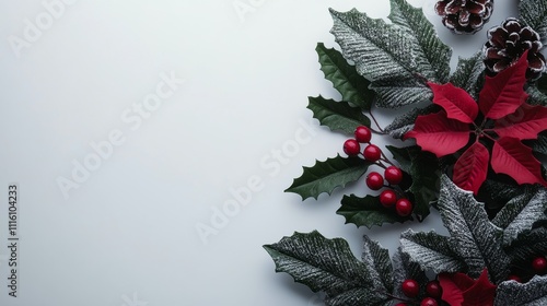Holiday floral arrangement with red poinsettias and pinecones on a light back...