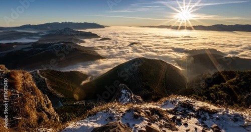Magic view of misty clouds motion in alps mountains landscape at golden sunrise Time lapse