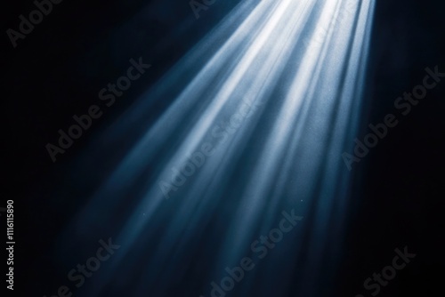 Ethereal streams of soft blue light radiate from an unseen source  creating an atmosphere of tranquility and awe in this abstract visualization of illumination.