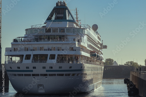 Classic luxury cruiseship cruise ship liner Amera in Montreal, Canada Quebec port during sunrise with harbor infrastructure and St Lawrence River coast line photo