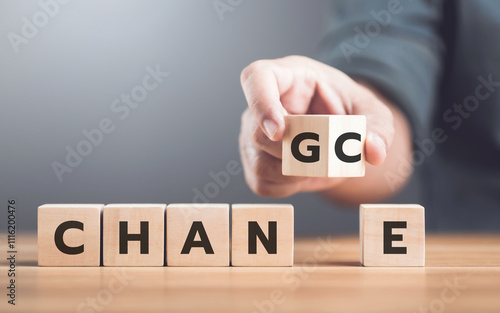 Man selects between the words 'CHANGE' and 'CHANCE' on wooden blocks, symbolizing the decision-making process and embracing opportunities for growth