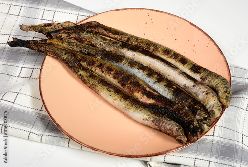 Fried lampreys on a plate and in a dish. Latvian lamprey recipes photo