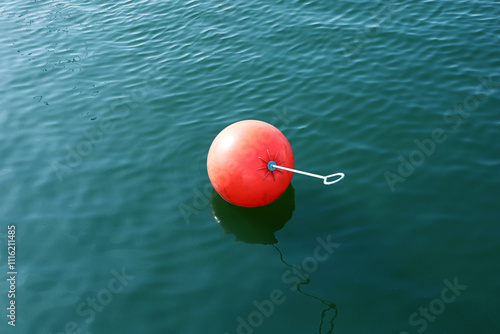 Fototapeta Naklejka Na Ścianę i Meble -  Orange water trail marker buoy floating on the water surface