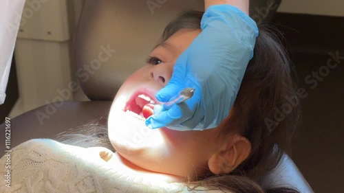 Girl receiving treatment by a dentist