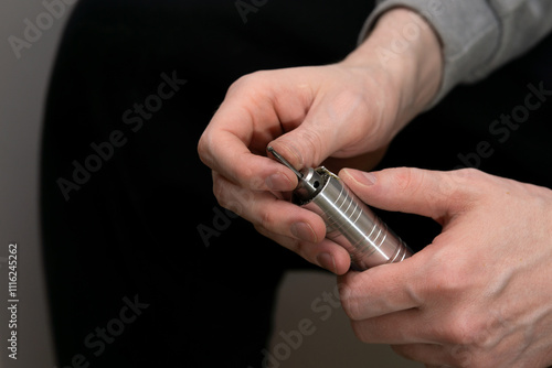 Billede på lærred Replacing the nozzle on the burr grinder, men's hands with engraver close-up