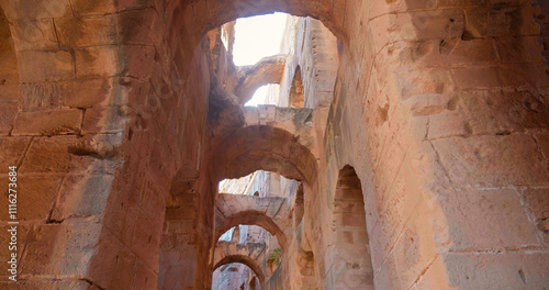 Archeological treasure of North Africa ruins of colloseum. Passage leading to different rooms in old building. photo