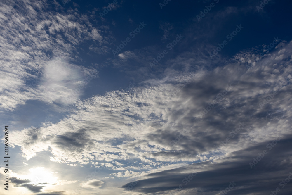 Fototapeta premium Dark blue sky with white moody clouds