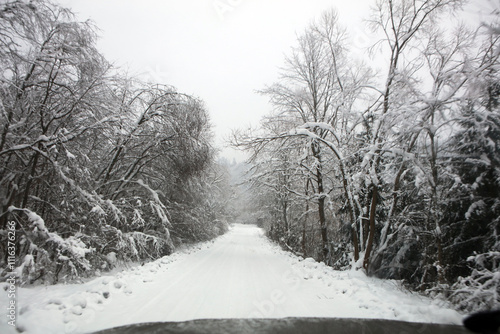 Fototapeta Naklejka Na Ścianę i Meble -  Snow covered road in Bieszczady Mountains in Poland