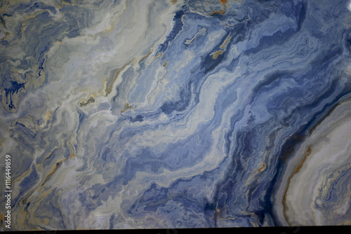 Blue Marble Surface with Wavy Patterns. Close-up of a blue marble surface featuring flowing, wavy patterns in soft shades of blue, white, and gold accents.

