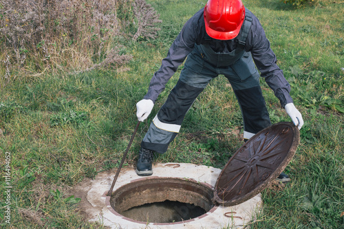 Canvas Print Worker opens septic well manhole cover