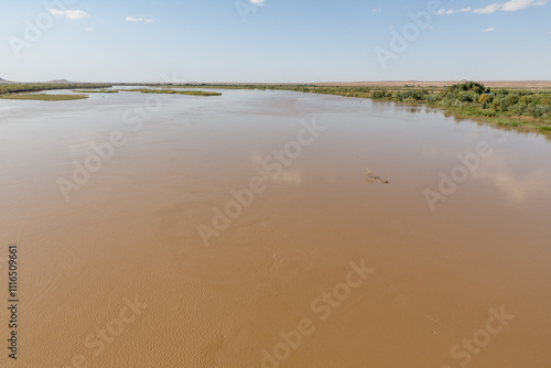 Amu Darya River flows peacefully near Kipchak village in Karakalpakstan Uzbekistan photo