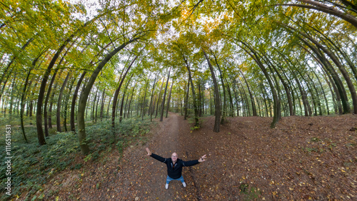 Happy and lonely balded Man in Autumn forest 