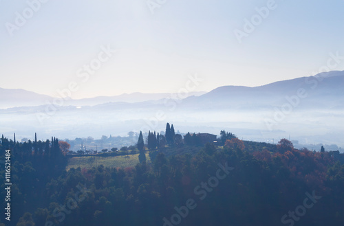 farmhouse nestled on a hilltop overlooking a peaceful umbrian valley photo