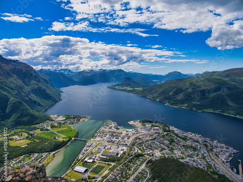 A view of the town of Andalsnes and the Romsdal Fjord in Norway. Taken from the Rampestreken view point on a sunny day in summer with a blue sky and white clouds.