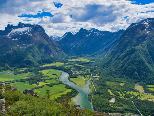 A view of the Rauma River and surrounding mountains near Andalsnes in Norway. Taken from the Rampestreken view point on a sunny day in summer with a blue sky and white clouds.