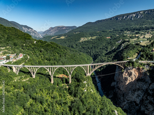 aerial view of durdevica Tara Bridge with tara river with blue water in mountains of montenegro