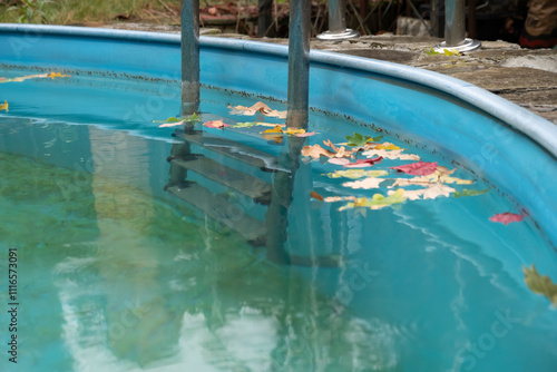 Sediments on bottom of swimming pool in autumn. Care and cleaning of water and walls of an outdoor pool. photo