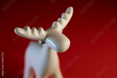 Obraz na płótnie A stylized White Moose Figurine on a vibrant red background, perfect for display w salonie