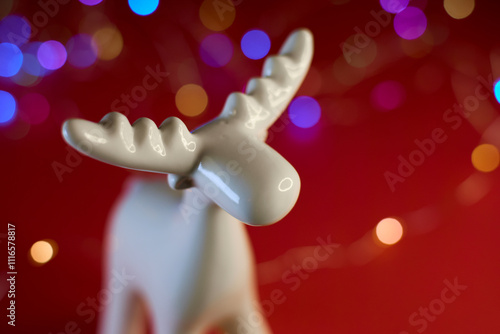 Obraz na płótnie A Beautiful White Moose Figurine Set Against a Bright and Colorful Bokeh Background w salonie