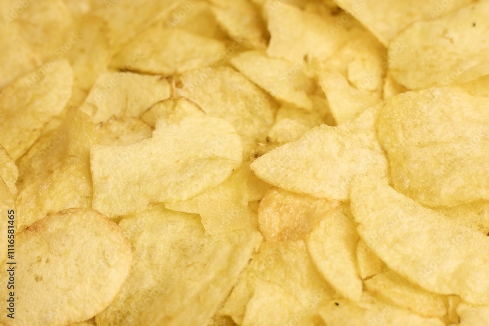 Textured background of crispy potato chips, ideal for design and branding purposes Textured background of crispy potato chips, ideal for design and branding purposes