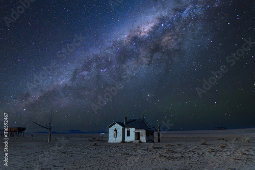 Milky way over the abandoned railway station Garub from German colonial time in Namibia desert. photo