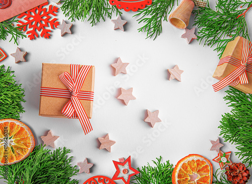 Obraz na płótnie Christmas background. Christmas eve concept. Top view of gift boxes, fir branches, toys, on white background. w salonie
