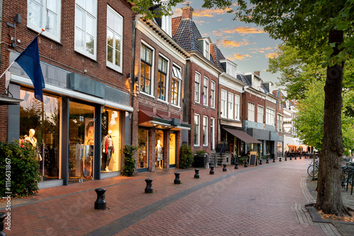 Small shopping street with restaurants in Diepswal street at evening, Dokkum, Netherlands photo