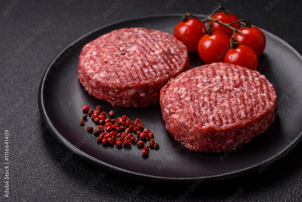 Fresh raw ground beef burger patty with salt and spices