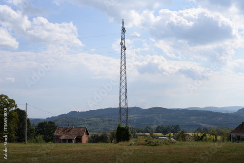 Electric power tower with lines, transporting electrical energy in countryside