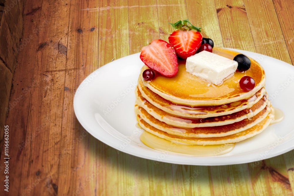 Buttermilk Pancakes with butter and maple syrup for breakfast. Buttermilk Pancakes with butter and maple syrup for breakfast.