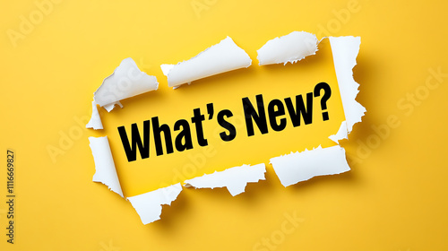 Torn Yellow Paper Revealing 'What's New?' Text