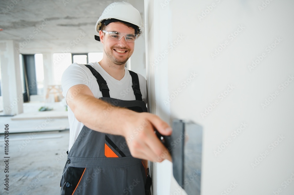 man drywall worker using trowel for plasterer putting stucco on plasterboard white wall man drywall worker using trowel for plasterer putting stucco on plasterboard white wall